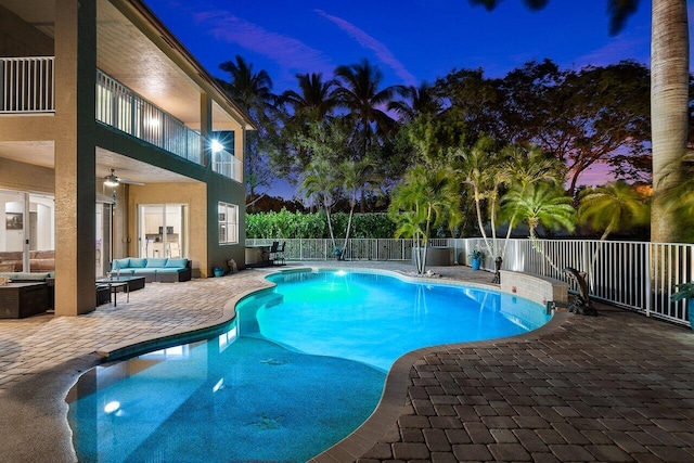 view of pool with a fenced in pool, fence, outdoor lounge area, a patio area, and ceiling fan
