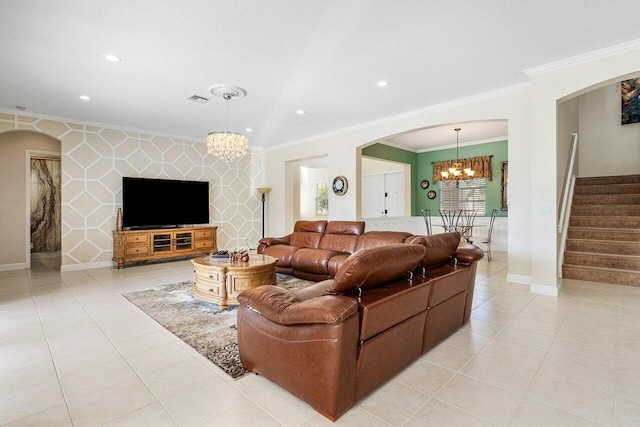 living room featuring arched walkways, stairs, ornamental molding, and an inviting chandelier