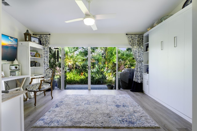 sitting room featuring wood finished floors, visible vents, and a ceiling fan