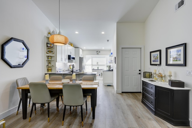 dining area with recessed lighting, light wood-style floors, visible vents, and baseboards