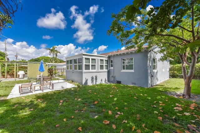 340 Russlyn Dr, West Palm Beach, FL 33405 - back of property with a patio area and stucco siding