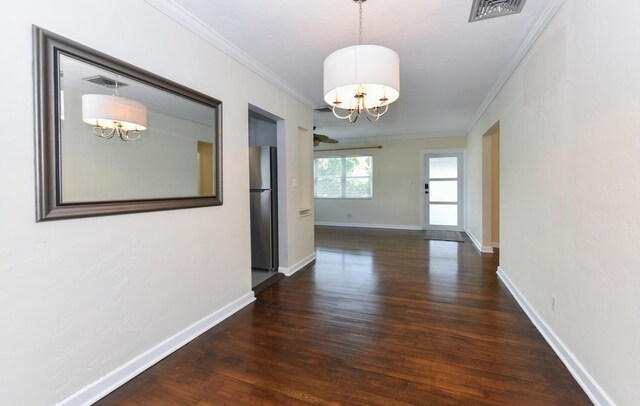 340 Russlyn Dr, West Palm Beach, FL 33405 - corridor with a chandelier, wood finished floors, crown molding, and baseboards
