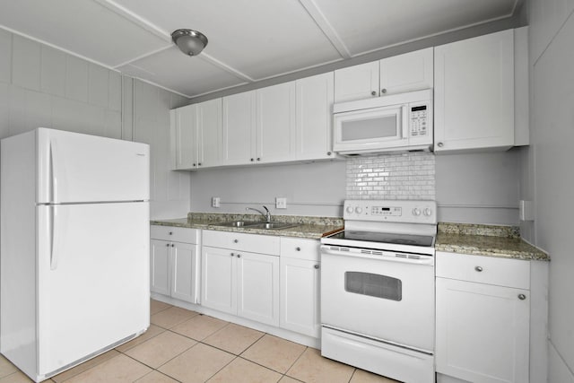 652 Bayberry Dr, Lake Park, FL 33403 - kitchen with white cabinets, a sink, light tile patterned floors, and white appliances