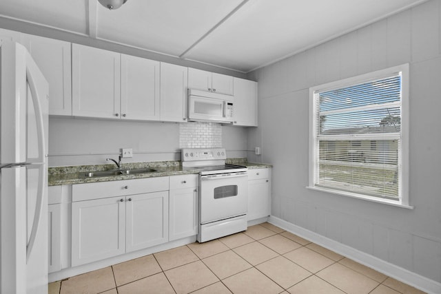 652 Bayberry Dr, Lake Park, FL 33403 - kitchen with white appliances, light tile patterned floors, a sink, white cabinets, and light stone countertops