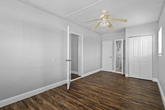 652 Bayberry Dr, Lake Park, FL 33403 - unfurnished bedroom with dark wood-type flooring, baseboards, and a ceiling fan