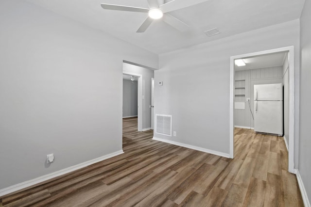 652 Bayberry Dr, Lake Park, FL 33403 - empty room featuring baseboards, visible vents, wood finished floors, and ceiling fan