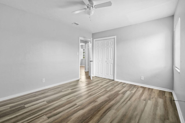 652 Bayberry Dr, Lake Park, FL 33403 - unfurnished bedroom with baseboards, visible vents, a closet, and wood finished floors