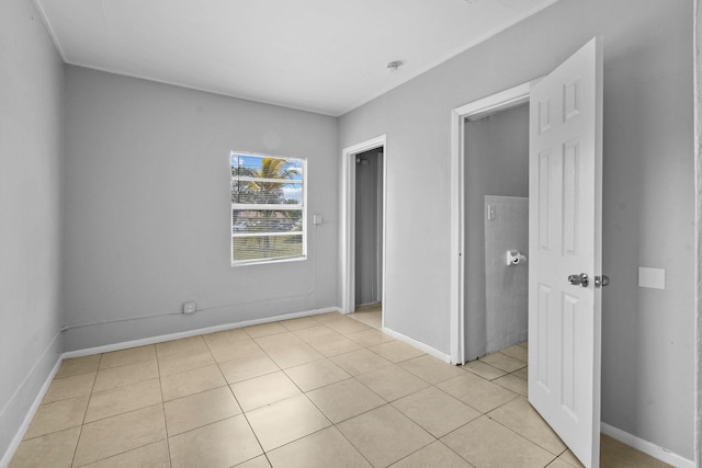 652 Bayberry Dr, Lake Park, FL 33403 - unfurnished bedroom with baseboards and light tile patterned floors