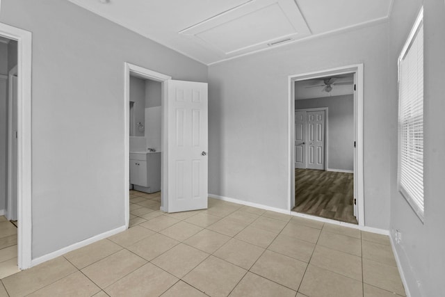652 Bayberry Dr, Lake Park, FL 33403 - unfurnished bedroom with light tile patterned flooring, baseboards, visible vents, and attic access
