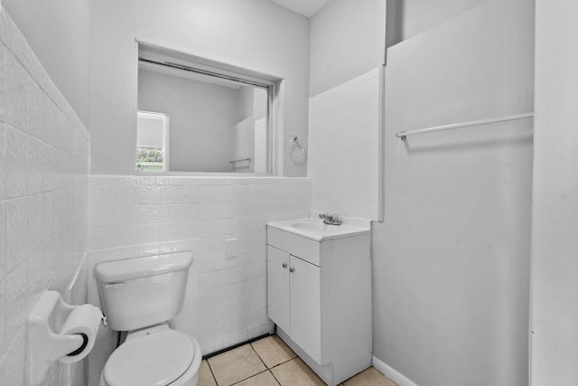 652 Bayberry Dr, Lake Park, FL 33403 - bathroom featuring tile patterned floors, toilet, vanity, and tile walls