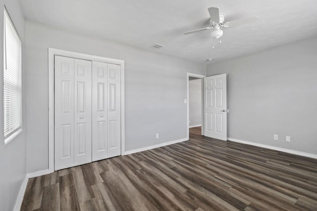 652 Bayberry Dr, Lake Park, FL 33403 - unfurnished bedroom with dark wood-style flooring, baseboards, a closet, and visible vents