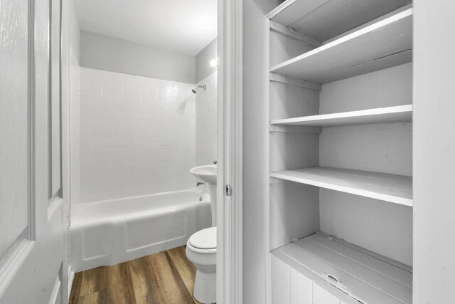 652 Bayberry Dr, Lake Park, FL 33403 - full bathroom with toilet,  shower combination, and wood finished floors