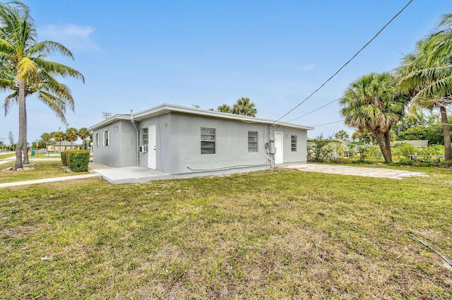 652 Bayberry Dr, Lake Park, FL 33403 - back of property featuring stucco siding, a yard, and a patio area