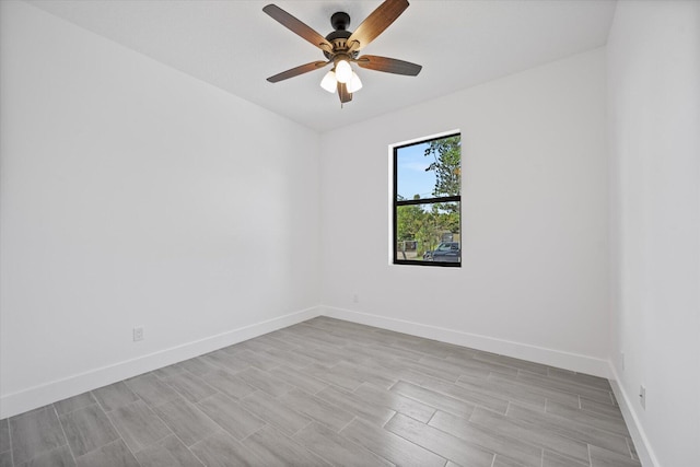 spare room featuring baseboards, a ceiling fan, and wood finished floors
