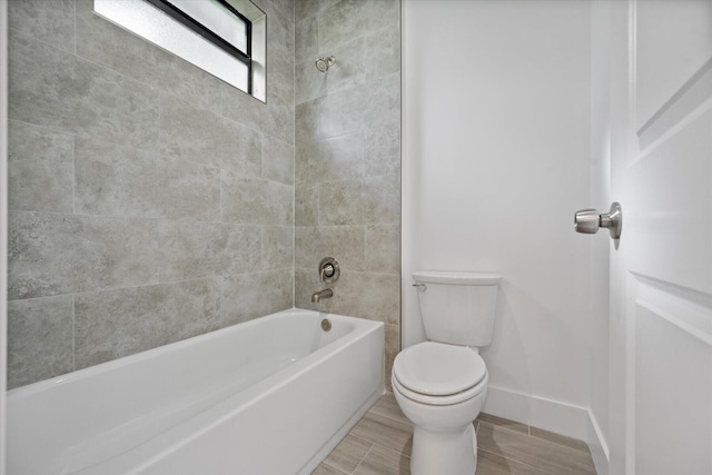 full bathroom with baseboards, toilet, and bathing tub / shower combination