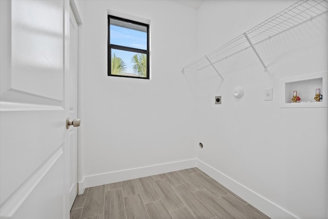 clothes washing area with laundry area, electric dryer hookup, wood finish floors, baseboards, and hookup for a washing machine