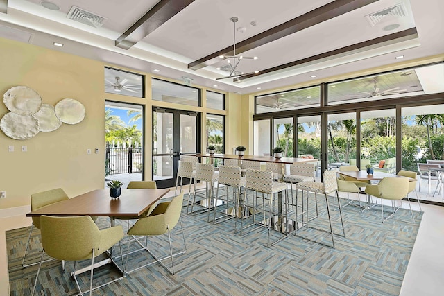 13471 Artisan Cir, Palm Beach Gardens, FL 33418 - carpeted dining area featuring french doors, healthy amount of natural light, beam ceiling, ceiling fan, and a towering ceiling