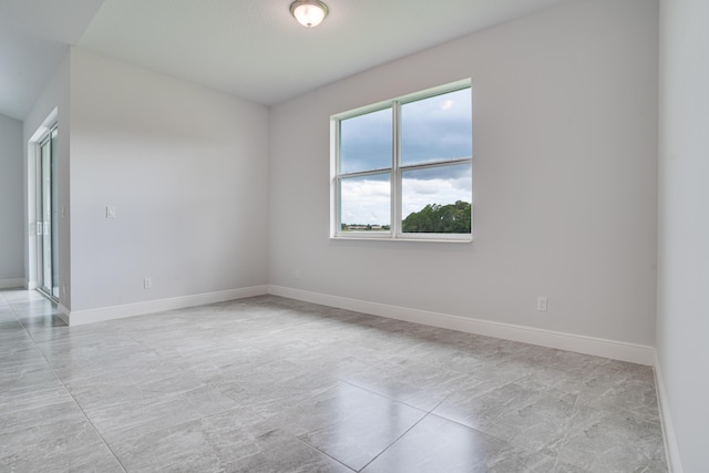 unfurnished room featuring baseboards