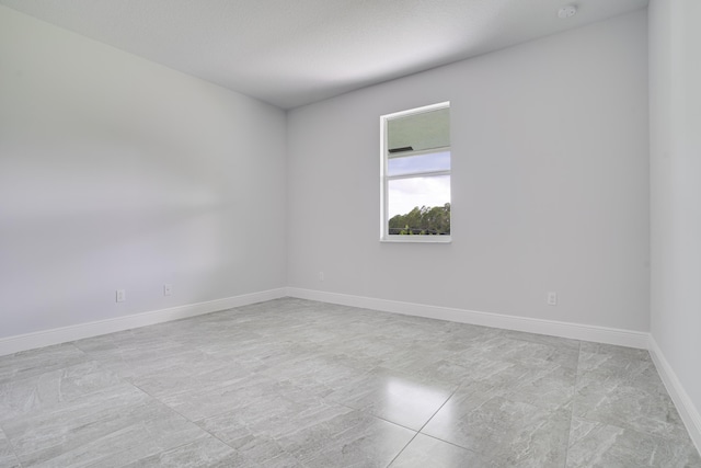 empty room featuring baseboards