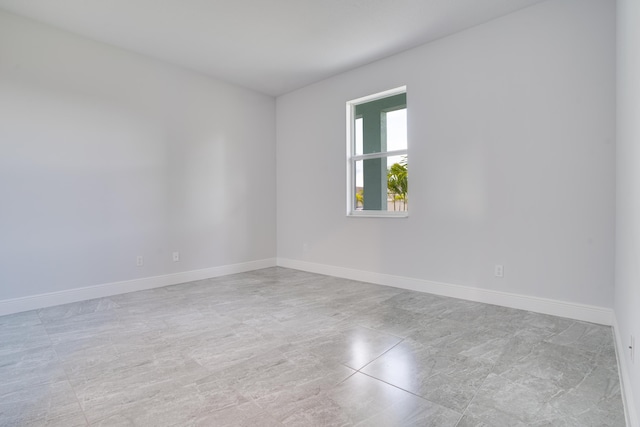 spare room with baseboards