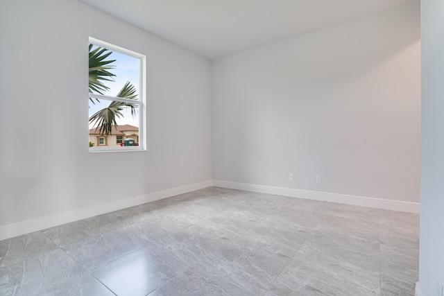 empty room featuring baseboards