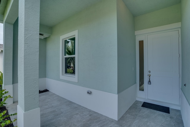 doorway to property with stucco siding