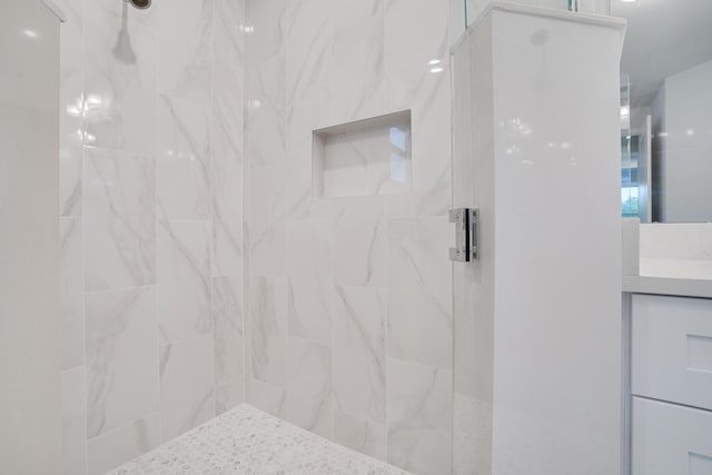 bathroom featuring vanity and a tile shower