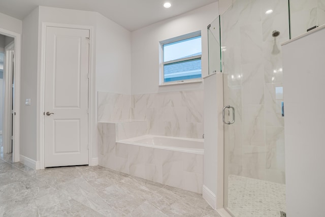 full bath featuring a garden tub and a marble finish shower