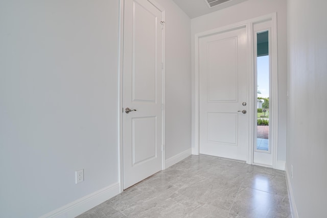 foyer featuring baseboards