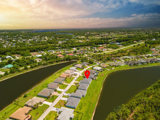 birds eye view of property with a water view and a residential view
