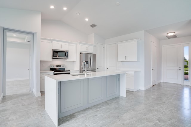 kitchen with light countertops, stainless steel appliances, a sink, an island with sink, and visible vents