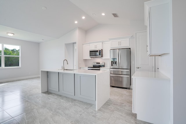 kitchen with an island with sink, light countertops, a sink, stainless steel appliances, and visible vents