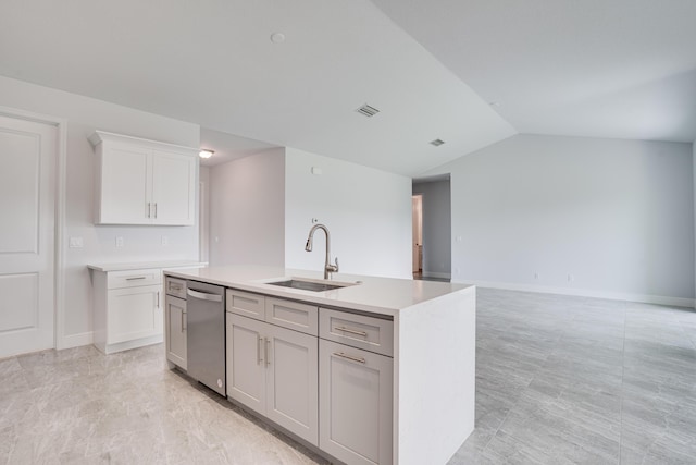 kitchen featuring an island with sink, light countertops, a sink, dishwasher, and lofted ceiling