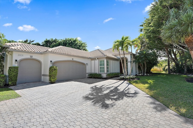 2651 Players Ct, Wellington, FL 33414 - mediterranean / spanish-style home featuring a tiled roof, stucco siding, a garage, and a front yard