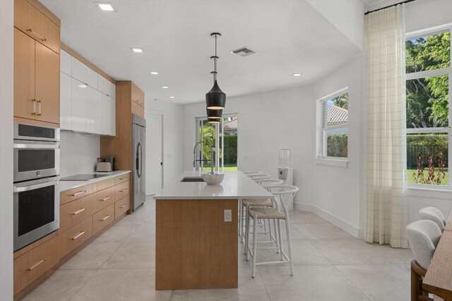2651 Players Ct, Wellington, FL 33414 - kitchen with stainless steel appliances, a sink, light countertops, plenty of natural light, and recessed lighting