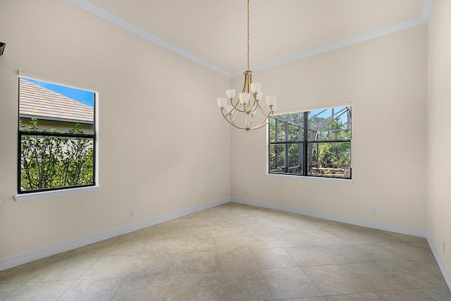 spare room with ornamental molding, baseboards, and a chandelier