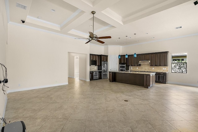 kitchen featuring open floor plan, a ceiling fan, under cabinet range hood, coffered ceiling, and stainless steel appliances