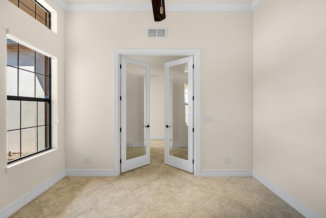 spare room featuring french doors, visible vents, baseboards, and plenty of natural light