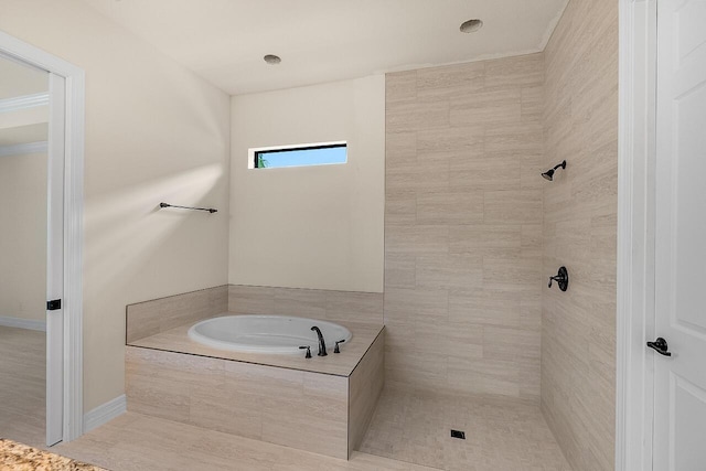 full bath featuring a bath and tiled shower