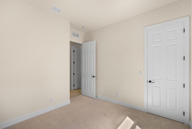 unfurnished bedroom featuring carpet flooring, baseboards, and visible vents