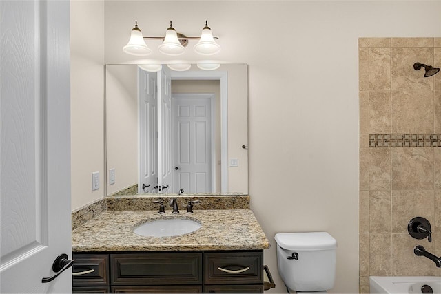 bathroom with vanity, bathtub / shower combination, and toilet