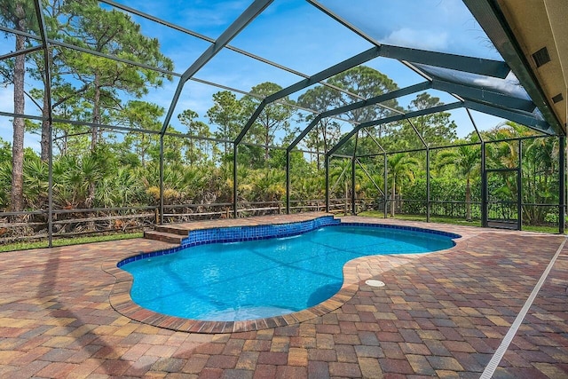 outdoor pool with a patio and a lanai