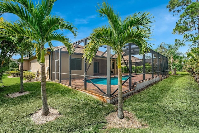 pool featuring a yard, a patio, and a lanai