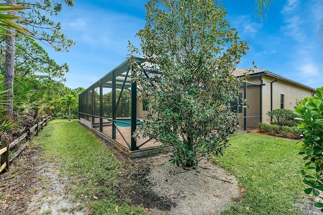 view of yard with an outdoor pool, glass enclosure, and a patio area