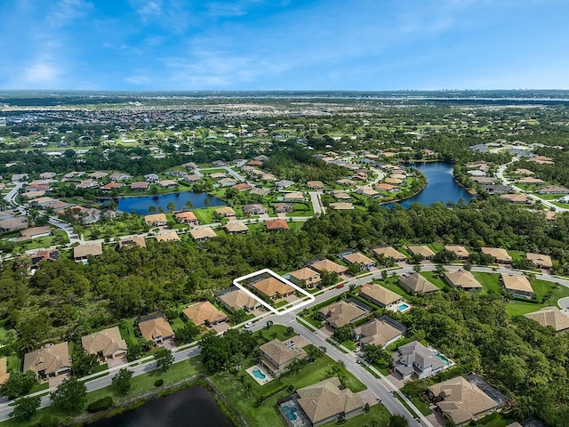 drone / aerial view with a residential view and a water view