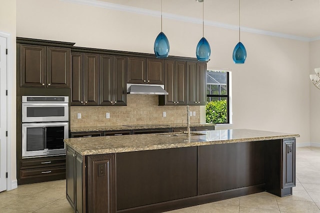 kitchen with crown molding, backsplash, light tile patterned flooring, under cabinet range hood, and stainless steel double oven