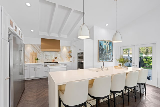 3510 Embassy Dr, West Palm Beach, FL 33401 - kitchen with a sink, decorative backsplash, appliances with stainless steel finishes, and an island with sink