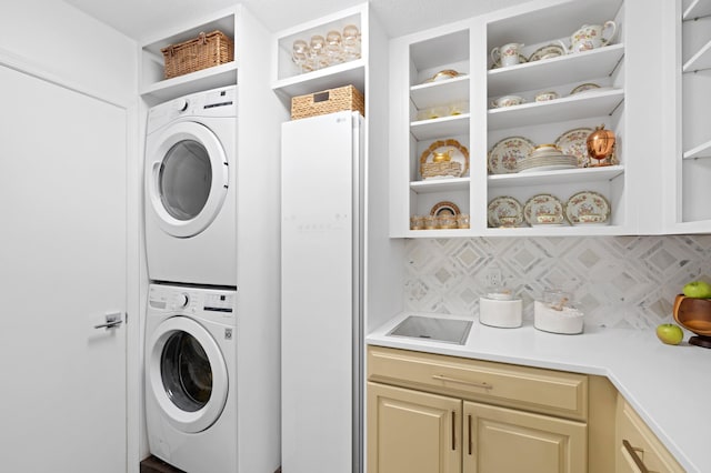 3510 Embassy Dr, West Palm Beach, FL 33401 - washroom featuring cabinet space and stacked washer and clothes dryer