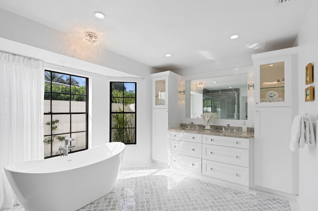 3510 Embassy Dr, West Palm Beach, FL 33401 - bathroom featuring a shower stall, a soaking tub, recessed lighting, and double vanity