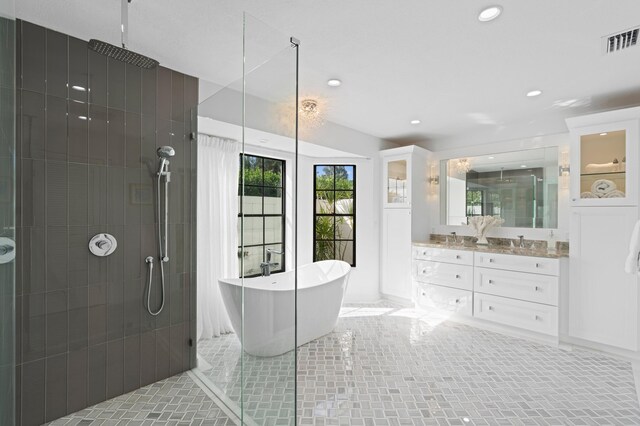 3510 Embassy Dr, West Palm Beach, FL 33401 - bathroom featuring visible vents, a tile shower, recessed lighting, a freestanding tub, and vanity